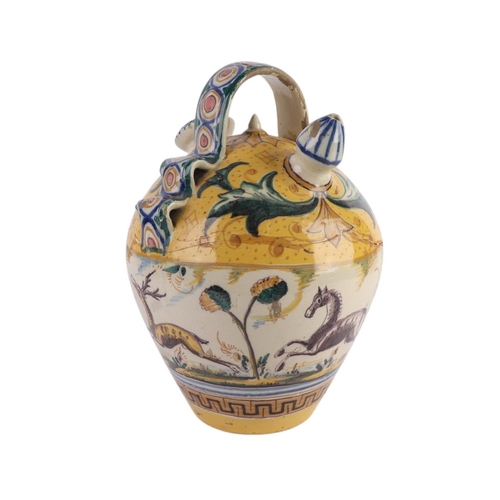 416 - A continental faience wine or water carrier; together with an arbarello of waisted form, decorated w... 