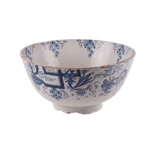 442 - An 18th century Delft blue & white footed bowl decorated with grapes, 30cms diameter.