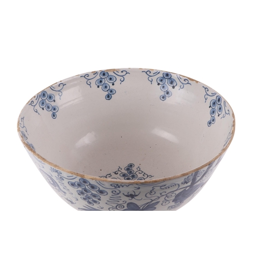 442 - An 18th century Delft blue & white footed bowl decorated with grapes, 30cms diameter.