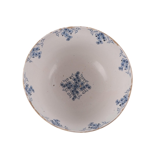 442 - An 18th century Delft blue & white footed bowl decorated with grapes, 30cms diameter.