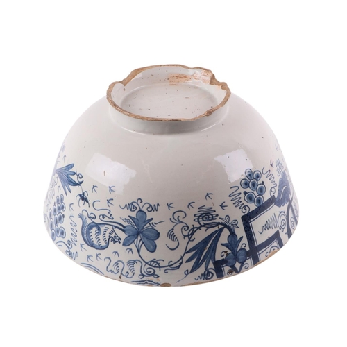 442 - An 18th century Delft blue & white footed bowl decorated with grapes, 30cms diameter.