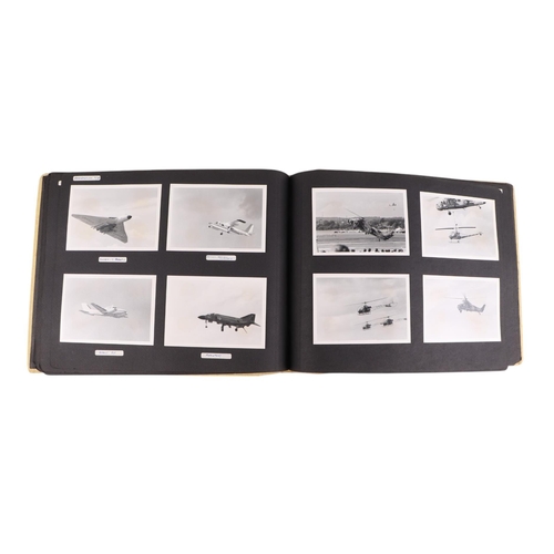 46 - A mid 20th century photograph album containing black & white photos of planes, helicopters and ships... 