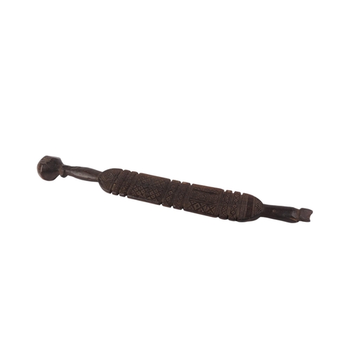 466 - Tribal Art:  A Tuareg Piquet carved wood awning tent peg with carved decoration, 71.5cms long.