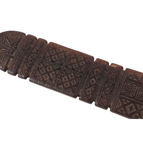 466 - Tribal Art:  A Tuareg Piquet carved wood awning tent peg with carved decoration, 71.5cms long.