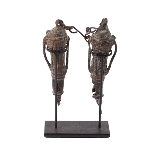 469 - A pair of Nigerian Yoruba Ogboni Edan staffs / figures, united by a chain, mounted on a museum type ... 