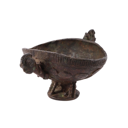 470 - An African (possibly Benin) ritualistic bowl with two figural handles, 13cms wide.