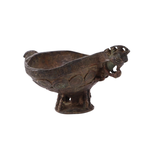 470 - An African (possibly Benin) ritualistic bowl with two figural handles, 13cms wide.