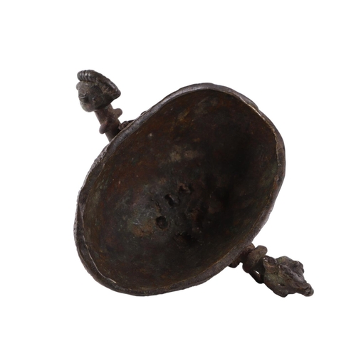 470 - An African (possibly Benin) ritualistic bowl with two figural handles, 13cms wide.