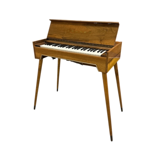 489 - A Hohner type 9812 mid 20th century walnut cased keyboard, 69cms wide.