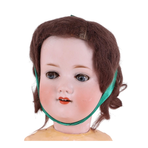 505 - An Armand Marseille bisque headed doll with jointed composite body, 59cms high.