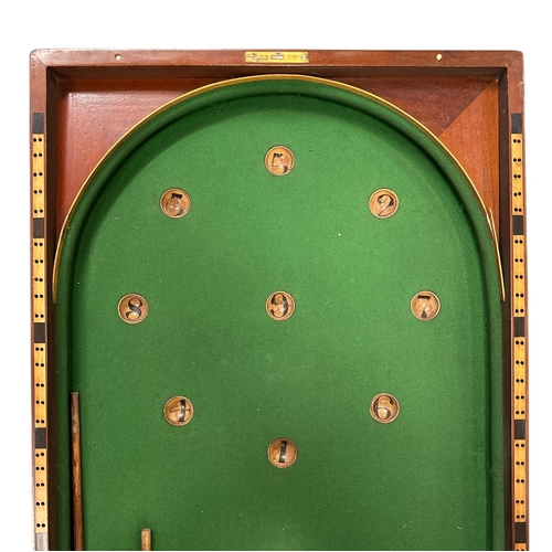 509 - A Victorian bar billiards game by A W Gamage, London, with green baize; lined playing surface, cues ... 