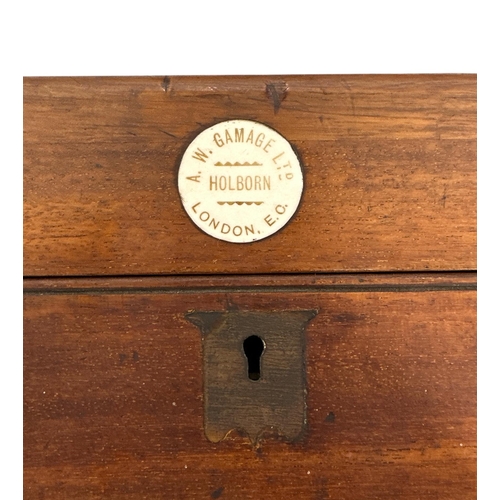 509 - A Victorian bar billiards game by A W Gamage, London, with green baize; lined playing surface, cues ... 