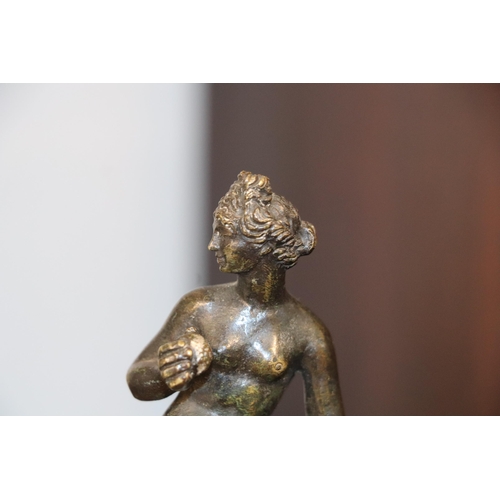 523 - A 19th century continental bronze figure of a woman holding fruit, possibly Eve, standing on a hexag... 