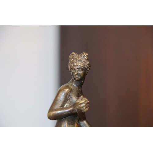 523 - A 19th century continental bronze figure of a woman holding fruit, possibly Eve, standing on a hexag... 