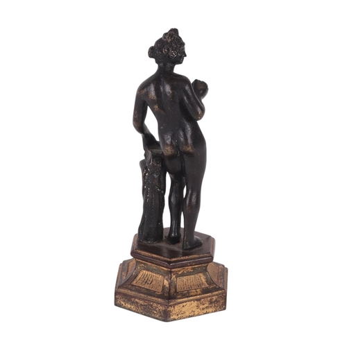 523 - A 19th century continental bronze figure of a woman holding fruit, possibly Eve, standing on a hexag... 