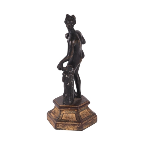 523 - A 19th century continental bronze figure of a woman holding fruit, possibly Eve, standing on a hexag... 