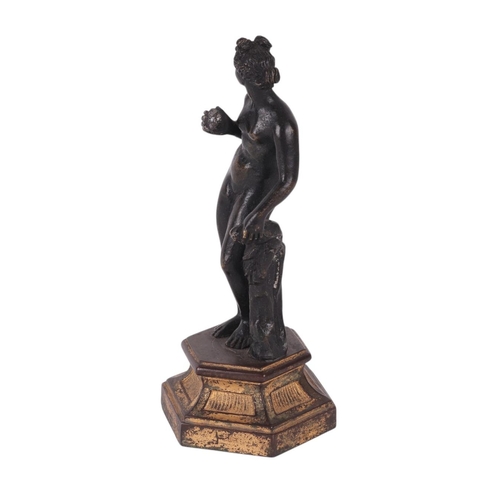 523 - A 19th century continental bronze figure of a woman holding fruit, possibly Eve, standing on a hexag... 