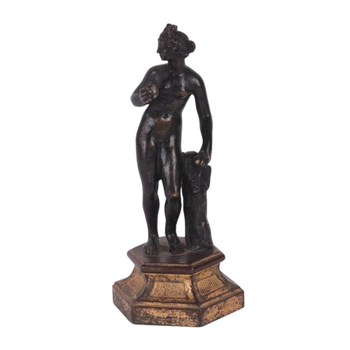 523 - A 19th century continental bronze figure of a woman holding fruit, possibly Eve, standing on a hexag... 