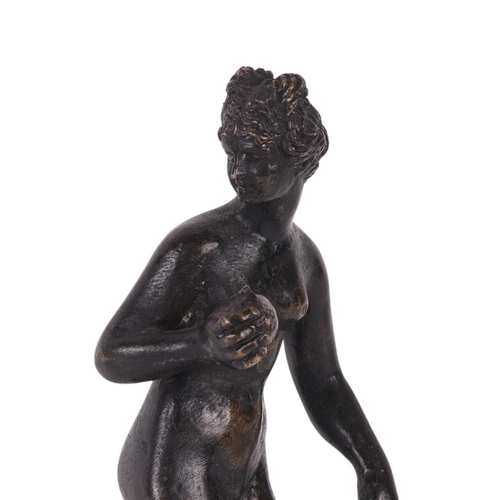 523 - A 19th century continental bronze figure of a woman holding fruit, possibly Eve, standing on a hexag... 