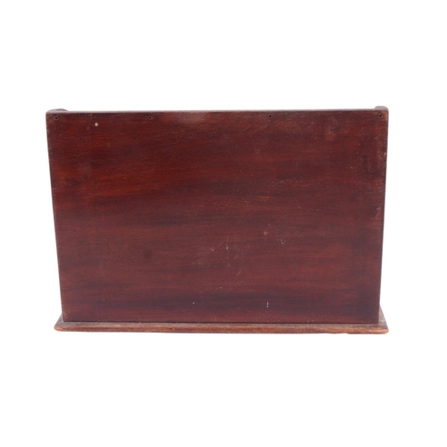 553 - An Edwardian inlaid mahogany desk top letter rack, 30cms wide.