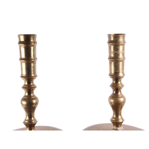 554 - A large pair of floor standing Indian brass candlesticks, 80cms high.