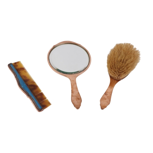 564 - An early 20th century enamelled three-piece dressing table set to include hand mirror, comb and brus... 