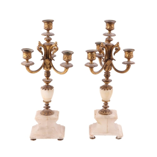 571 - A pair of gilt metal and onyx three-branch candelabra, 44cms high (2).