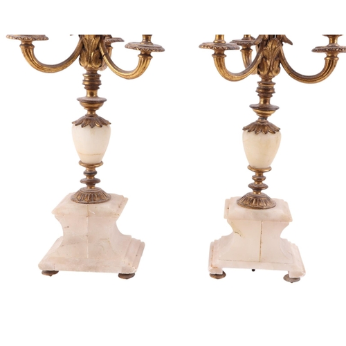 571 - A pair of gilt metal and onyx three-branch candelabra, 44cms high (2).