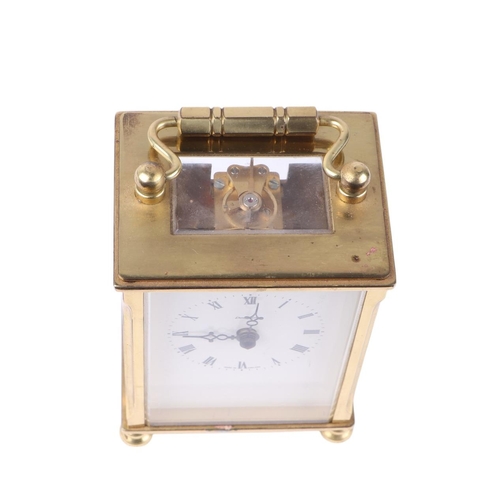 623 - A brass cased carriage time piece, the white dial signed 'Dominion', with Roman numerals, 13cms high... 