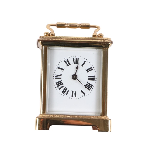 626 - A brass cased carriage time piece, the white enamel dial with Roman numerals, fitted in a leather tr... 