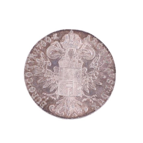 674 - A Maria Theresa Thaler coin; together with other coins.