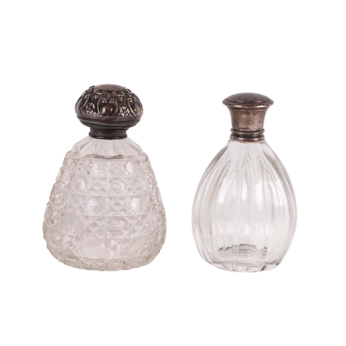 702 - A Victorian silver topped scent bottle, London 1857; together with an Edwardian silver topped scent ... 