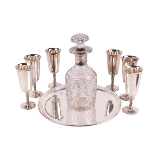 708 - A set of six silver plated goblets on a silver plated tray with cut glass white metal mounted decant... 