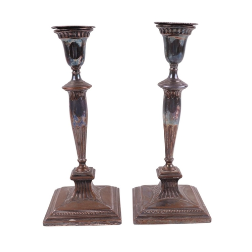 711 - A pair of 19th century Old Sheffield plate candlesticks, 27cms high.