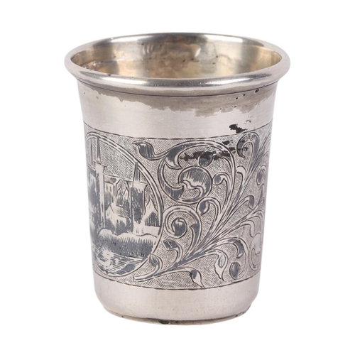 715 - A Russian silver beaker with niello decoration depicting a riverside town scene, 6.5cms high.