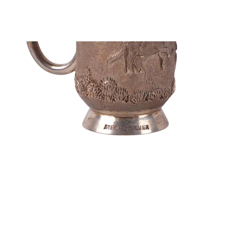 738 - An Indian sterling silver tankard decorated with figures in a landscape, boxed, 118g.