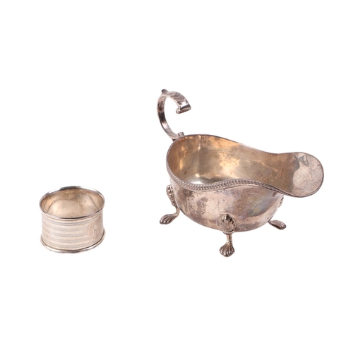 741 - A silver sauce boat, Birmingham 1922; together with a silver napkin ring, 144g (2).