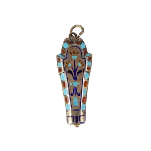 749 - An Egyptian Revival white metal and enamel sarcophagus pendant opening to reveal a gilded interior c... 