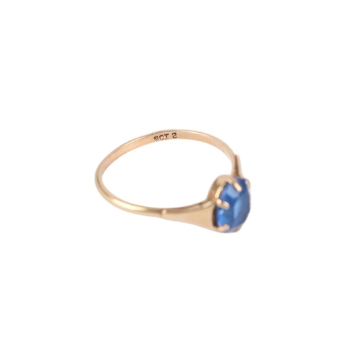 769 - A 9ct gold dress ring set with an oval blue stone, approx UK size L, 1.2g.