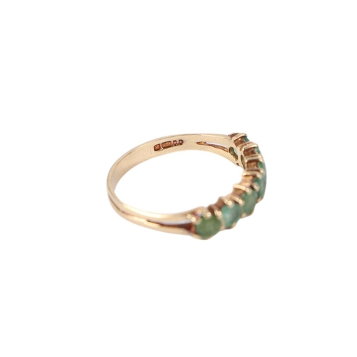 776 - A 9ct gold seven-stone emerald half eternity ring, approx UK size L, 1.3g.