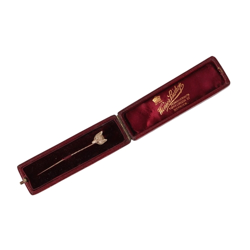 788 - A late 19th / early 20th century 9ct gold fox head stick pin with ruby set eyes, boxed, 2.6g.