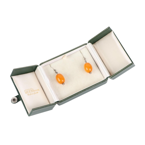 797 - A pair of egg yolk amber drop earrings.