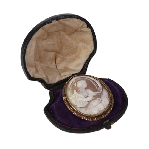 803 - A Victorian gilt metal mounted cameo brooch depicting a lady with a harp, 4.5 by 5cms, boxed.