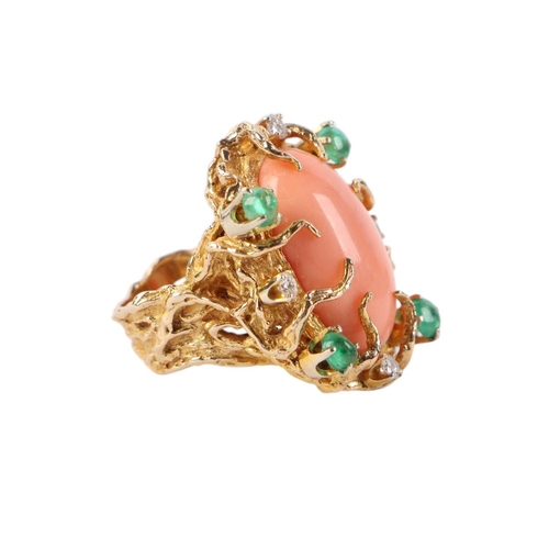 815 - A 1960's 14ct gold naturalistic cocktail ring set with a large oval coral cabochon within a diamond ... 