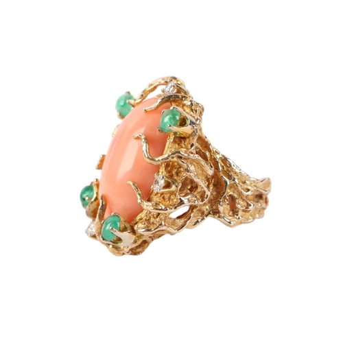 815 - A 1960's 14ct gold naturalistic cocktail ring set with a large oval coral cabochon within a diamond ... 