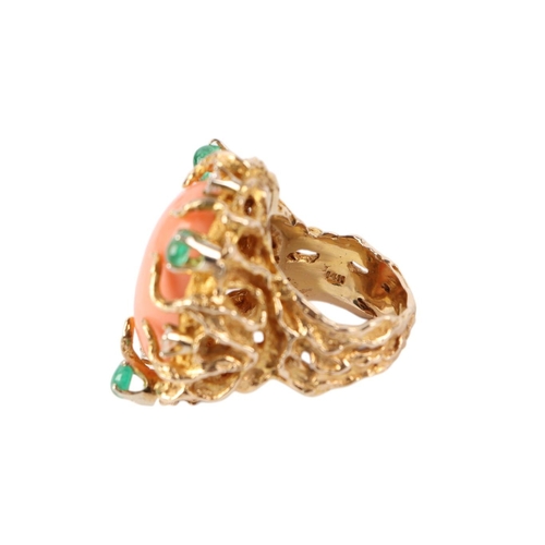 815 - A 1960's 14ct gold naturalistic cocktail ring set with a large oval coral cabochon within a diamond ... 