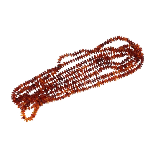 861 - A very long Baltic amber bead necklace; together with a double strand amber necklace, 232g total wei... 