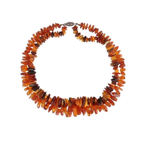 861 - A very long Baltic amber bead necklace; together with a double strand amber necklace, 232g total wei... 