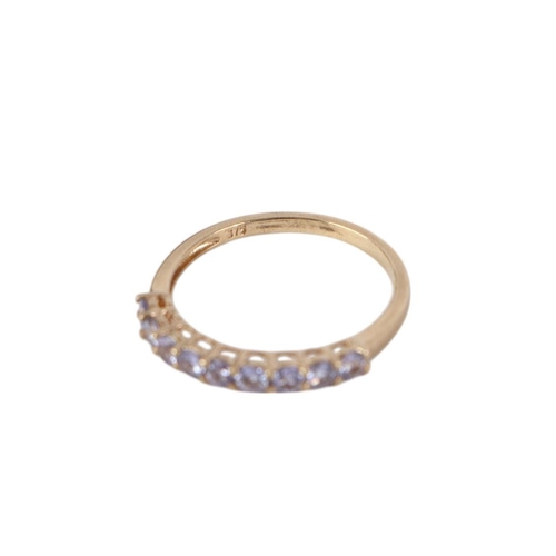 871 - A 9ct gold half eternity ring set with nine pale purple stones, approx UK size P, 1.3g.