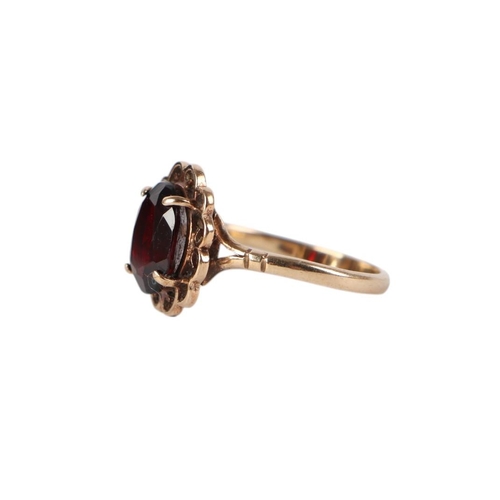 872 - A 9ct gold garnet dress ring, approx UK size N, 2.6g.